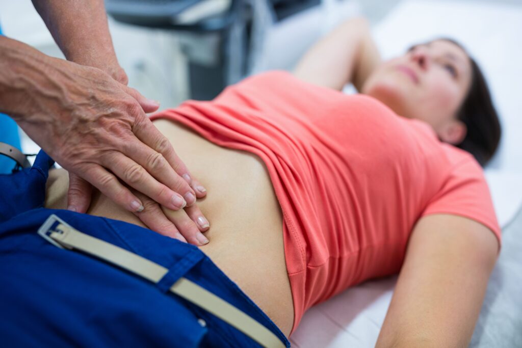 doctor attend patient ultrasound in abdomen