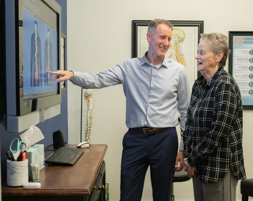 Dr. Craig Ellison showing patient a digital spine model